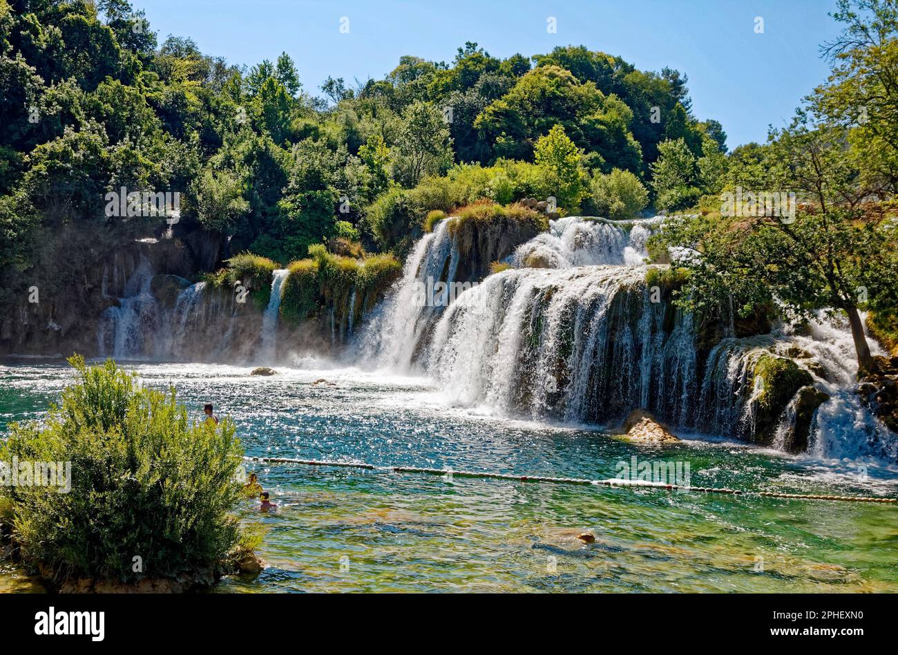 waterfalls; nature; powerful; scenic; wooded setting, green trees, few people, swimming, frecreation, fun, Krka National Park; Dalmatia; Croatia; Euro Stock Photo