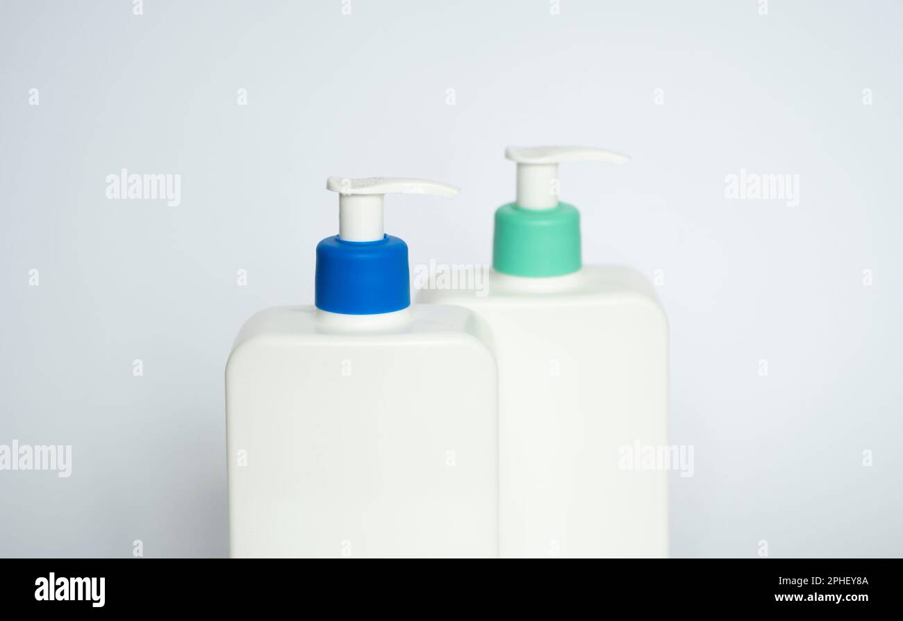 Two white plastic bottles with black dispenser, isolated on white ...