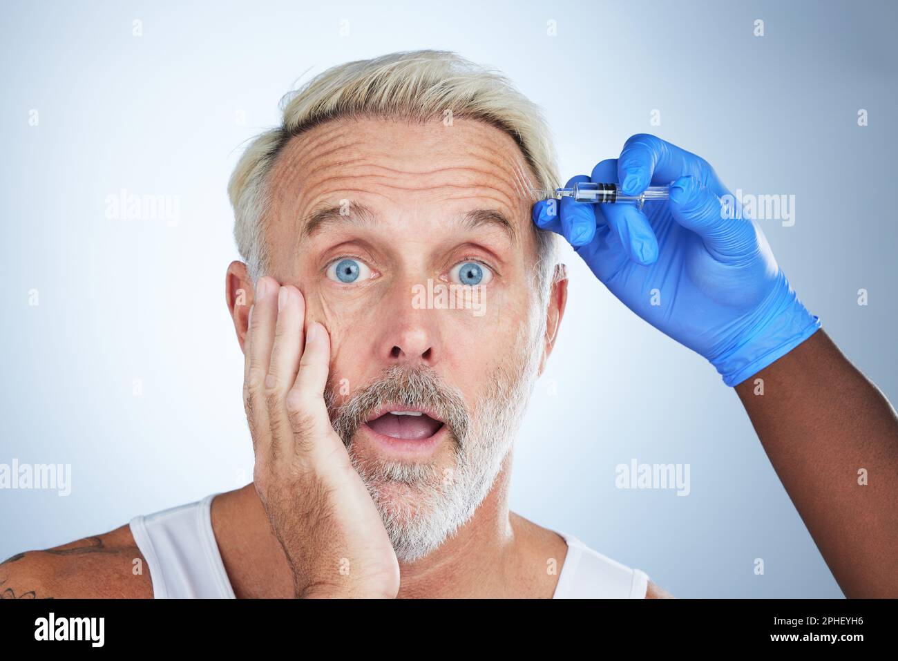 Botox, wow portrait and surprise of a senior man in a studio doing plastic surgery and cosmetic skincare. Dermatology, wrinkles and anti aging Stock Photo