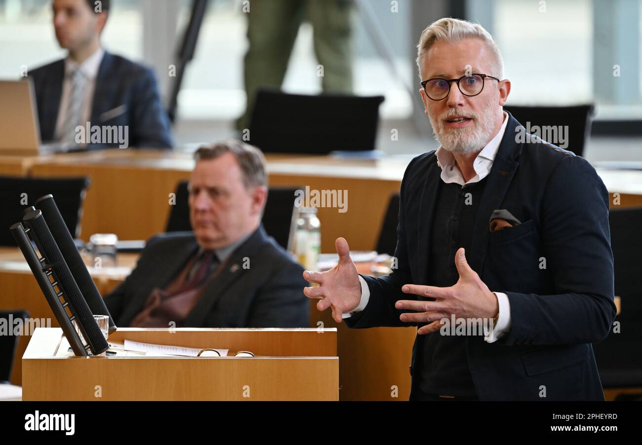 28 March 2023, Thuringia, Erfurt: Benjamin-Immanuel Hoff (Die Linke), Head of the State Chancellery and Minister for Culture, Federal and European Affairs of Thuringia, speaks at the special plenary session of the Thuringian Parliament. Bodo Ramelow (Die Linke), prime minister of Thuringia, sits in the background. The deputies are debating the state government's personnel decisions in hiring top officials. The special plenary session was requested by the CDU faction and the FDP group. The background is an audit report by the State Audit Office on 'staffing in the management areas of the highes Stock Photo