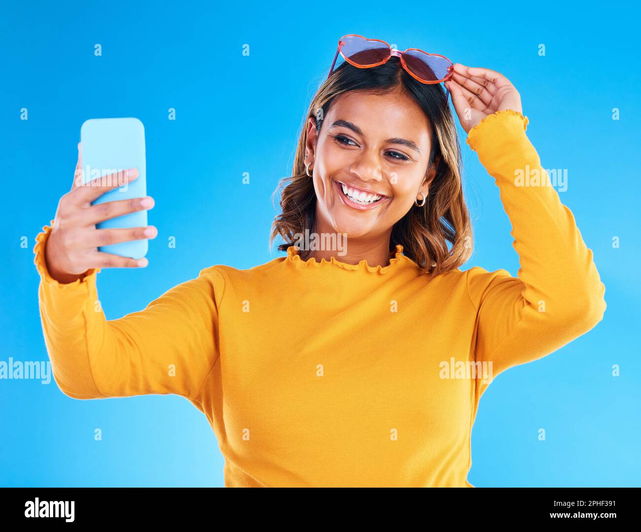 Woman, face and smile in studio for selfie, social media or vlog in