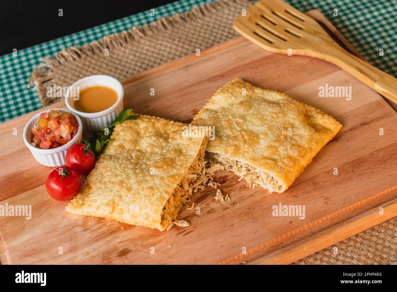 A high-angle closeup shot of a plate of food featuring a pastel filled with a variety of meats Stock Photo