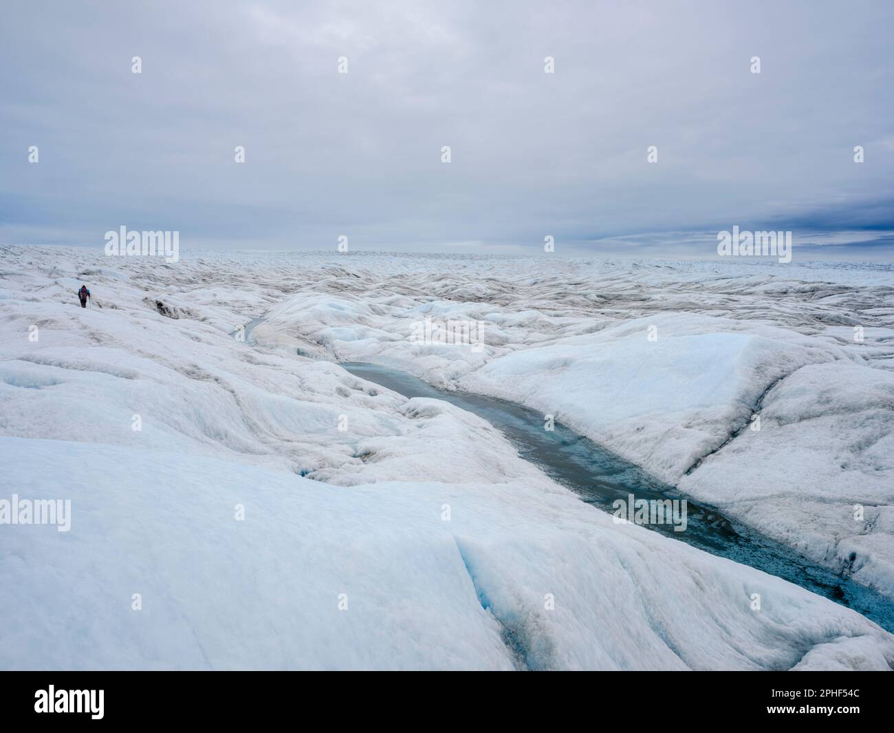 Tourists hiking on the ice. The brown sediment on the ice is created by ...