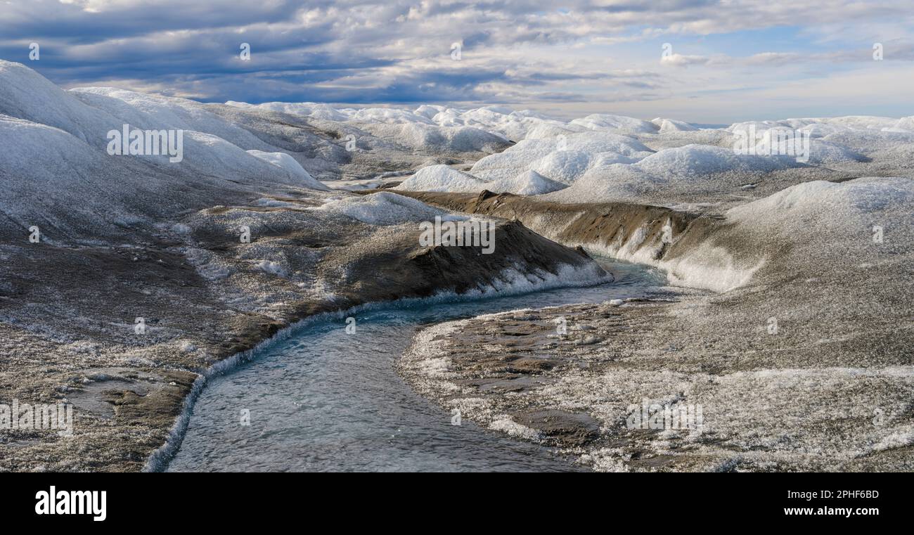 Drainage system on the surface of the ice sheet. The brown sediment on ...