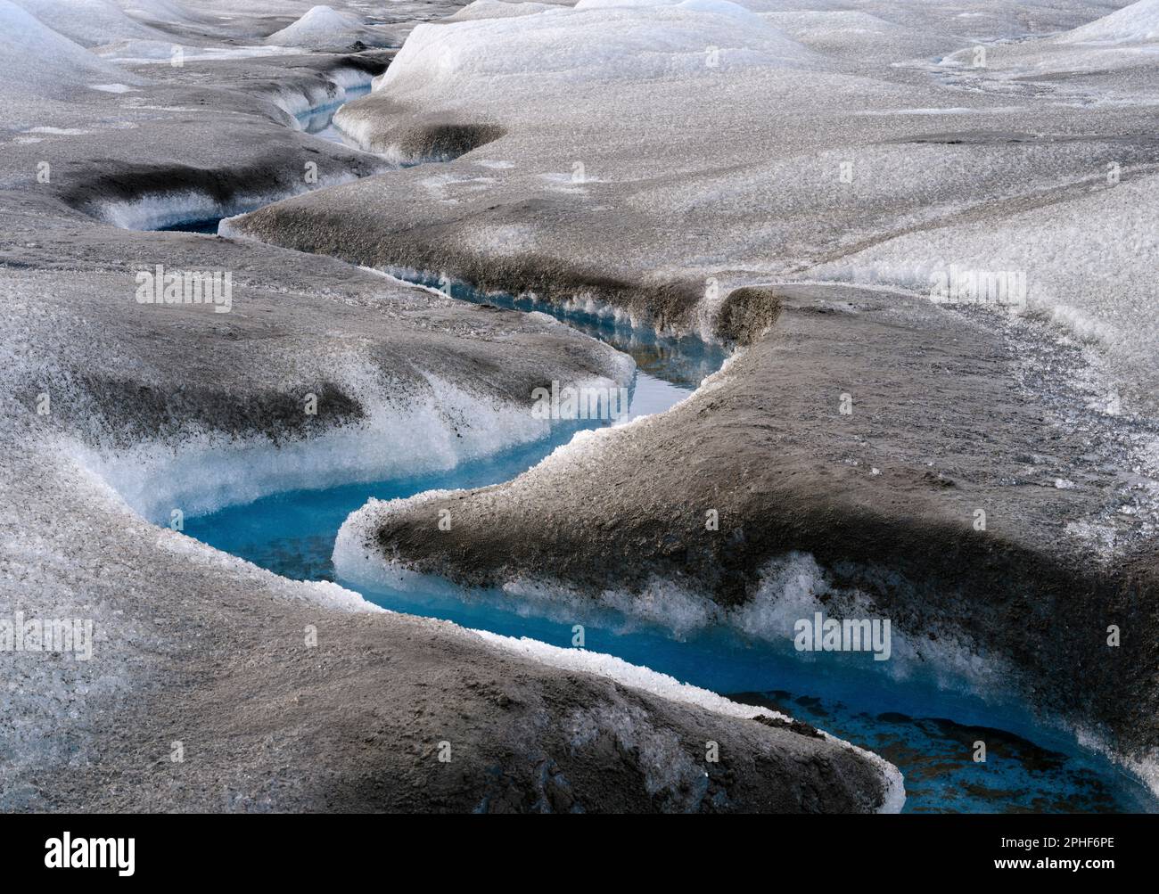 Drainage system on the surface of the ice sheet. The brown sediment on ...