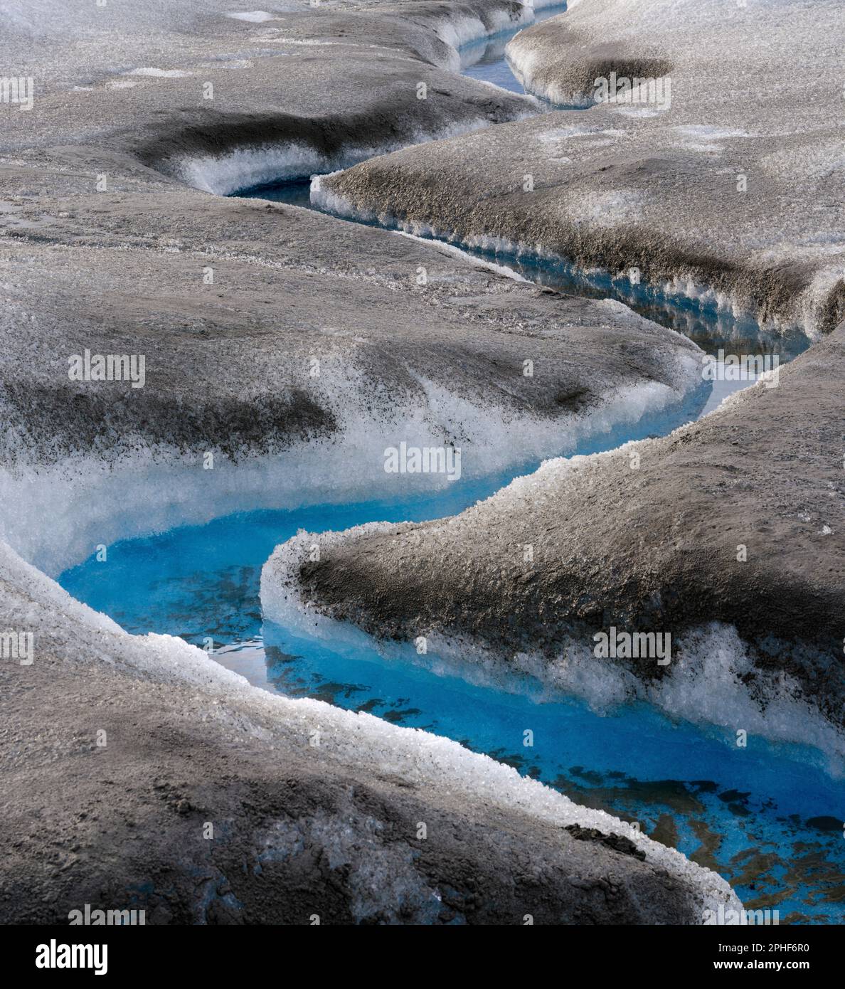 Drainage system on the surface of the ice sheet. The brown sediment on ...