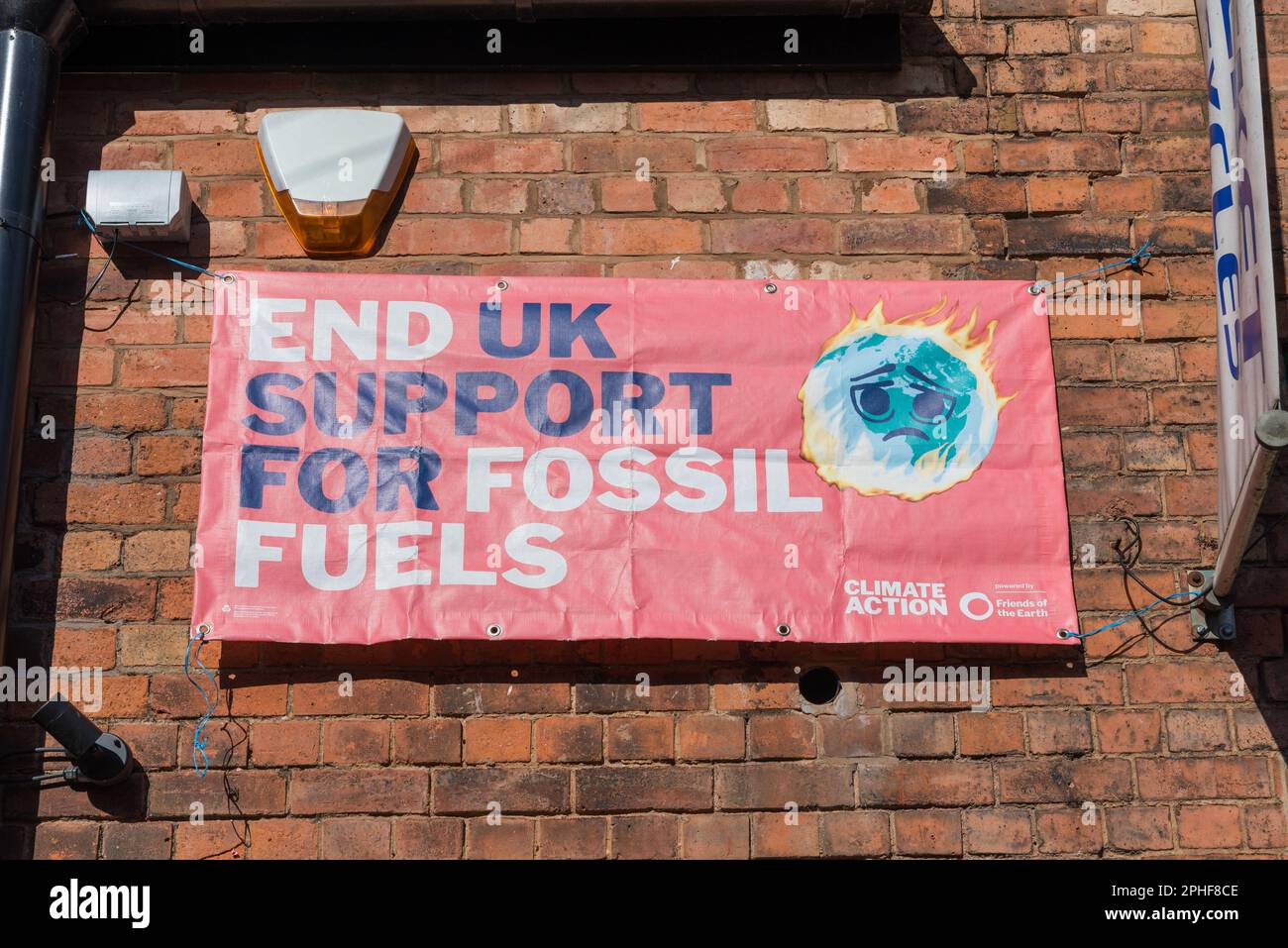 Climate action banner saying end uk support for fossil fuels on the front of the Warehouse Cafe in Digbeth Stock Photo