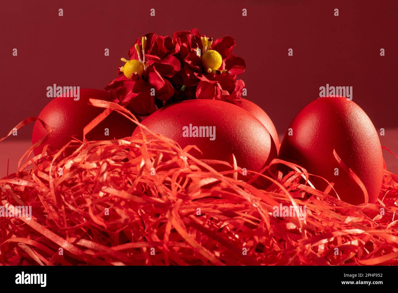 Colored eggs symbolize Easter in shades of red on straw Stock Photo Alamy