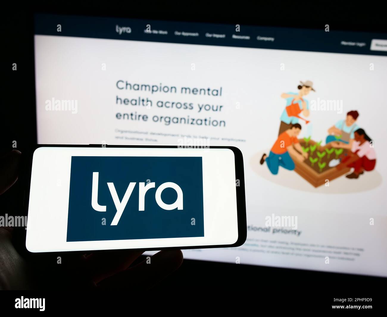 Person holding cellphone with logo of US mental health company Lyra Health Inc. on screen in front of business webpage. Focus on phone display. Stock Photo