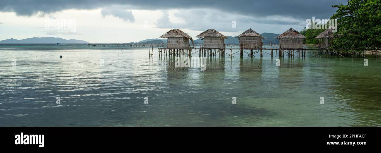 Destroyed water house on the coast of the village of Saporkren Waisai, Raja Ampat, background cloudy sky Stock Photo