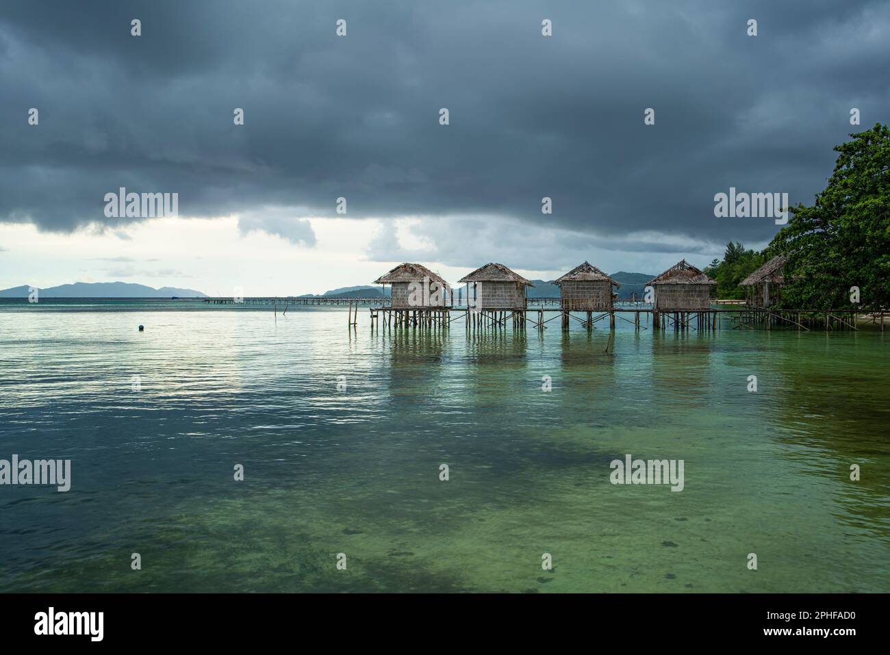 Destroyed water house on the coast of the village of Saporkren Waisai, Raja Ampat, background cloudy sky Stock Photo