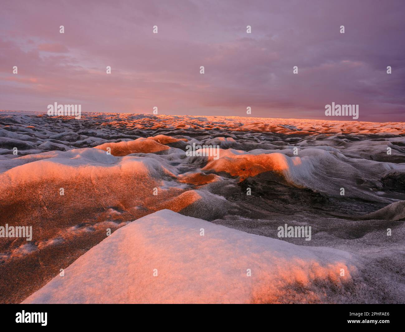 Midnight sun on the ice sheet. The brown sediment on the ice is created