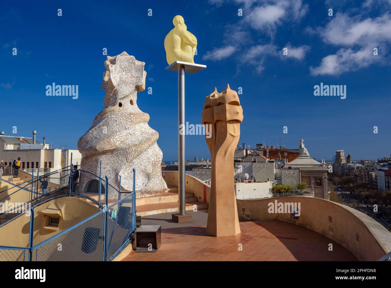 Sculpture 'Day-Night' (2012) by the artist Jaume Plensa and the chimneys in the terrace of Casa Milà - La Pedrera during the spring of 2023, BCN Spain Stock Photo