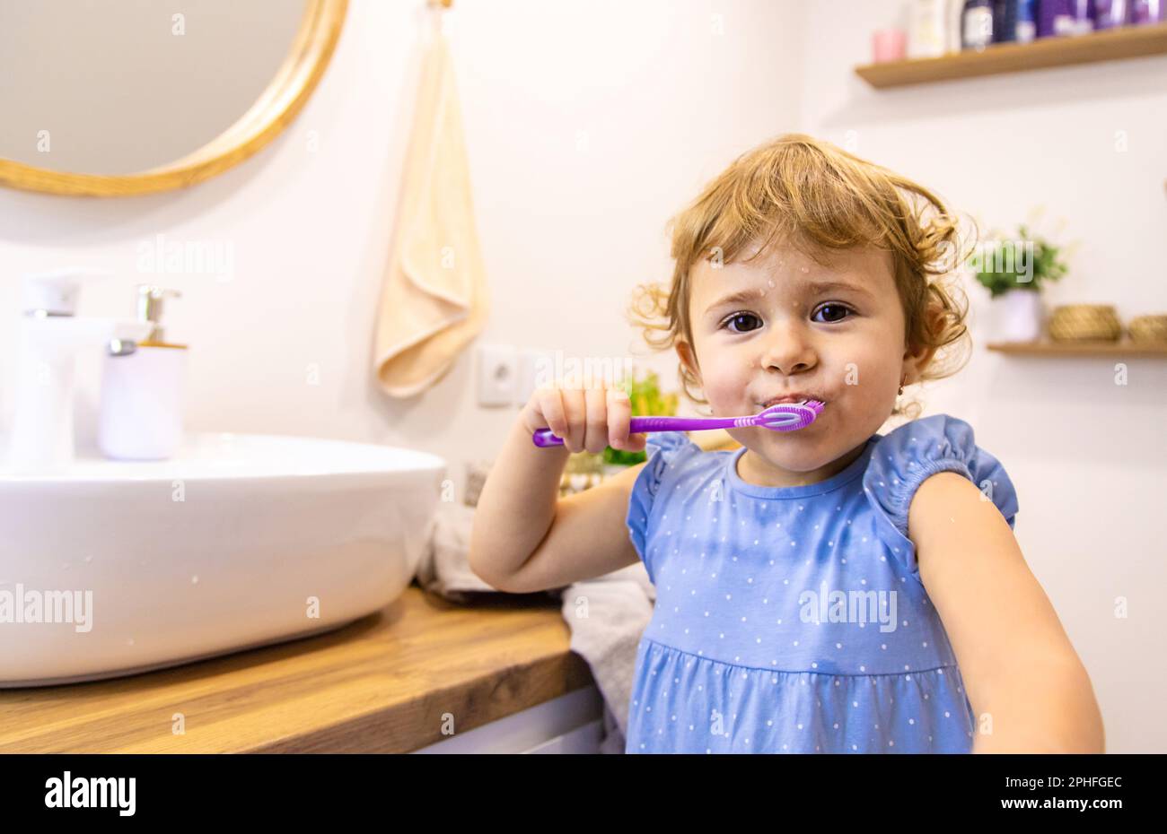 The child brushes his teeth in the bathroom. Selective focus. Nature