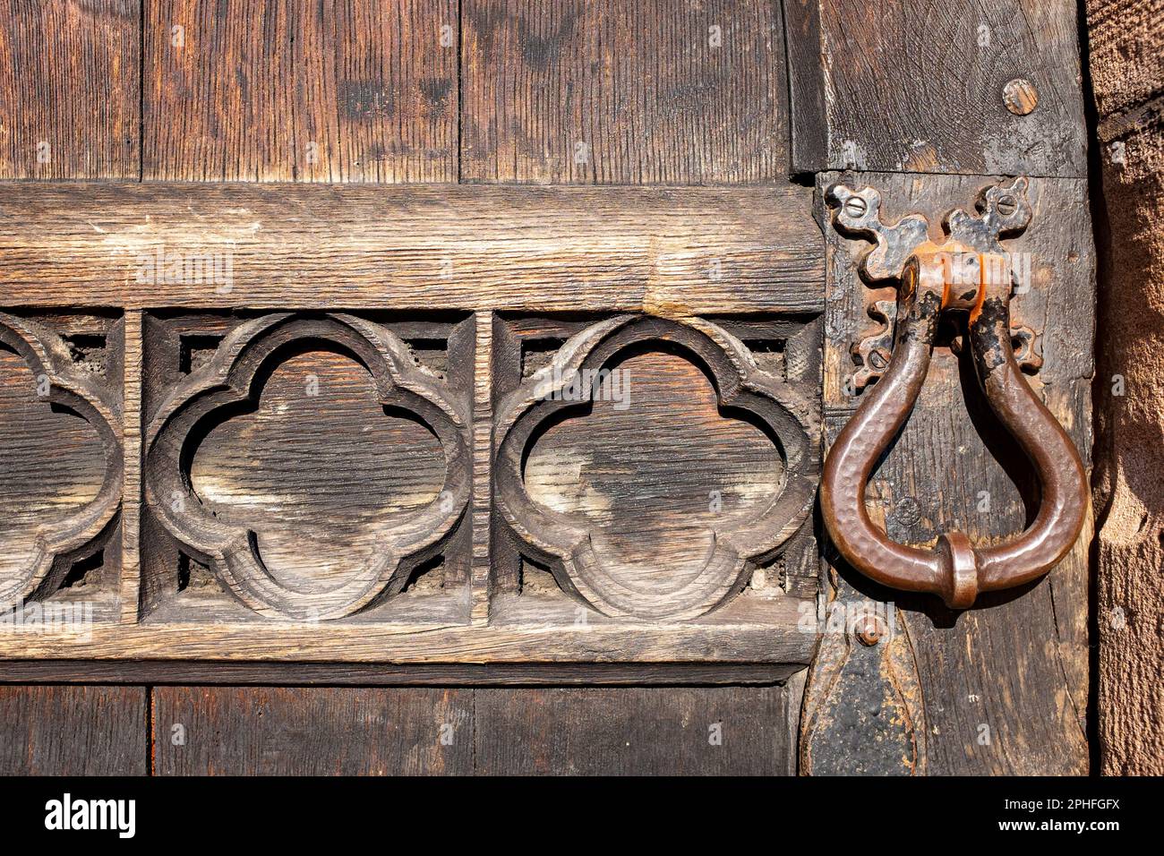 Detail of old oak church door with door handle UK Stock Photo