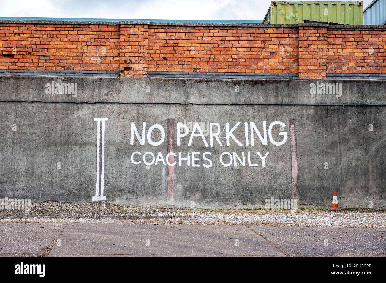 No Parking coaches only, traffic warning sign painted on concrete wall UK Stock Photo