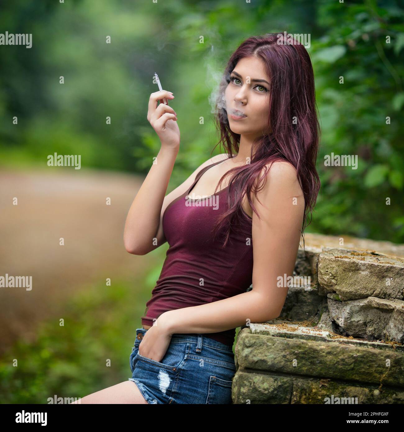 an-attractive-young-woman-with-red-hair-smoking-a-cigarette-while