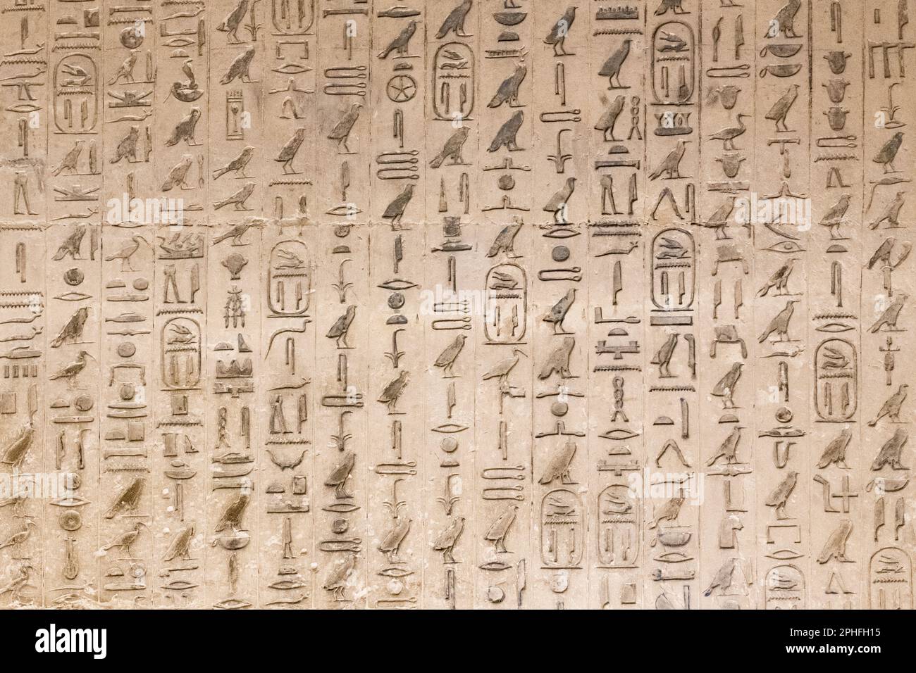 Authentic hieroglyphic inscriptions inside an underground burial chamber by the Pyramid of Djoser at the Saqqara Necropolis in Giza, Egypt Stock Photo