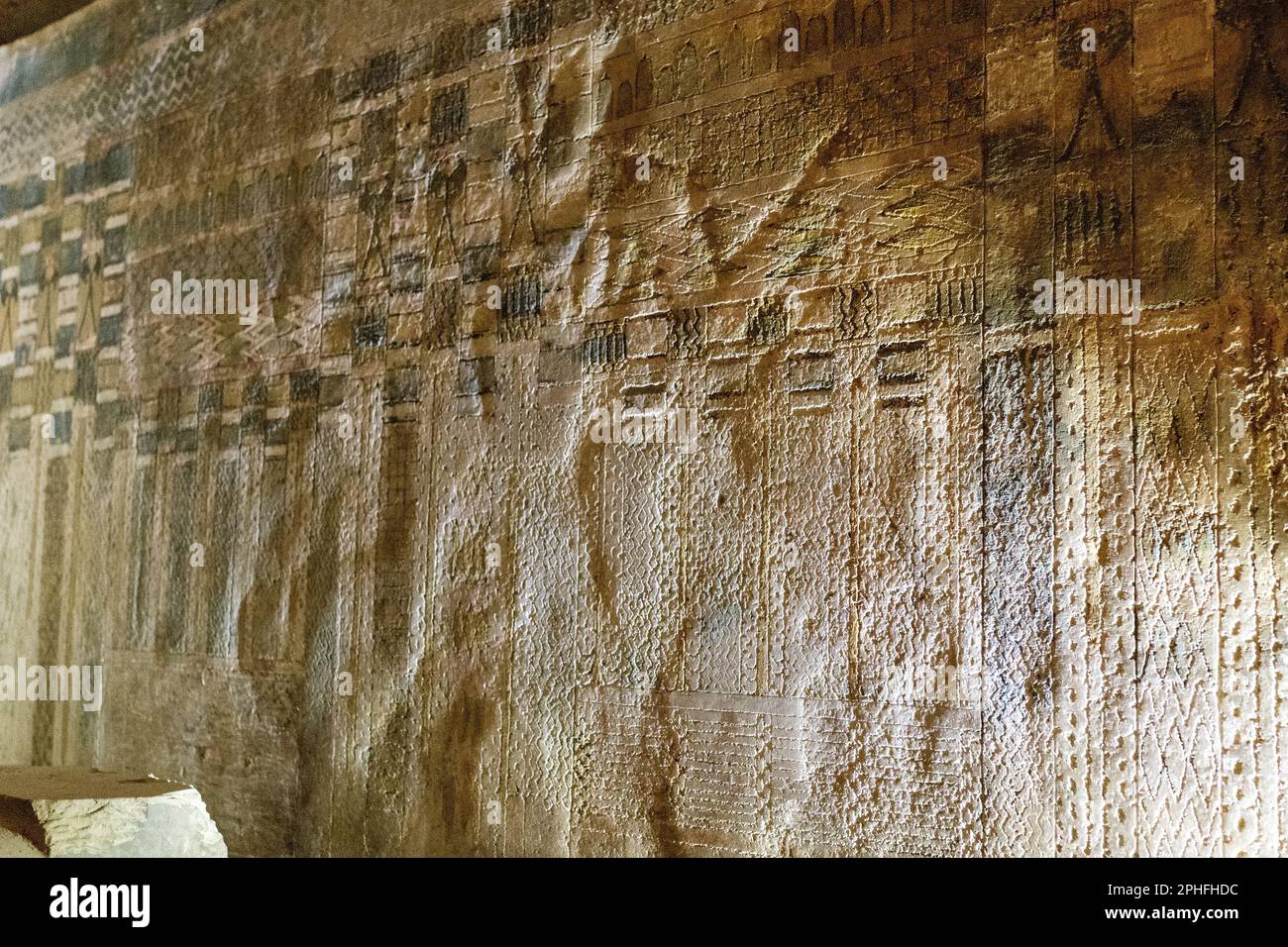 Hidden relief carvings on the wall in the underground burial chamber tomb of Unas by the Pyramid of Djoser at the Saqqara Necropolis in Giza, Egypt Stock Photo