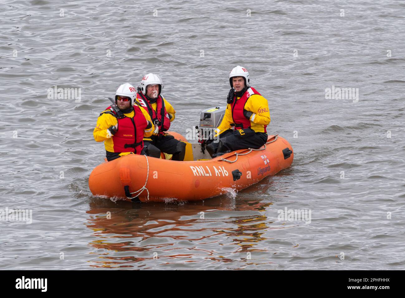 RNLI safety boat on River Thames at Chiswick, London, UK, for the University Boat Race 2023