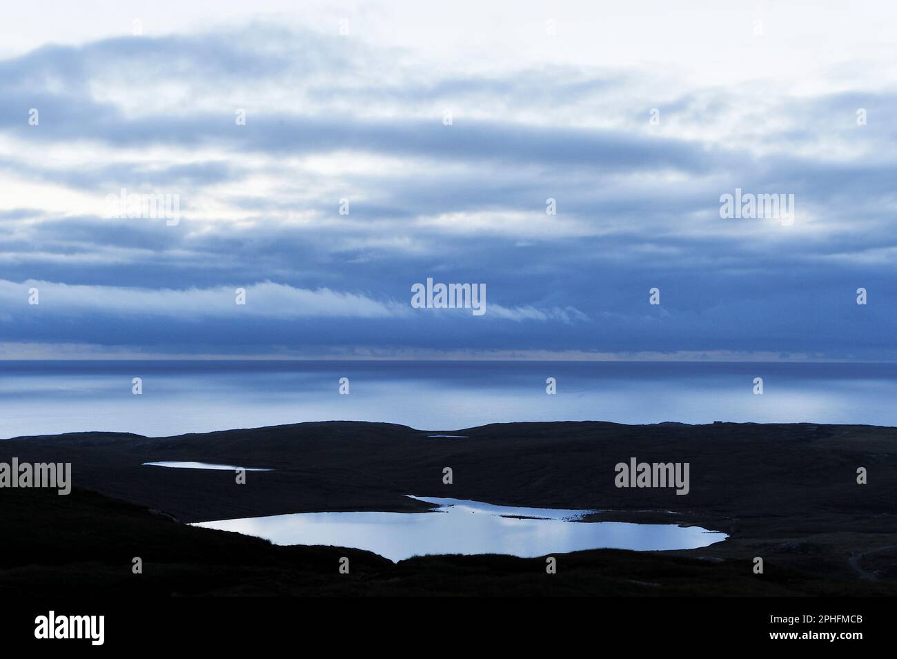 View to the west over Atlantic Ocean at dusk from high viewpoint above Uig, Lewis, Outer Hebrides, Scotland, August 2009 Stock Photo