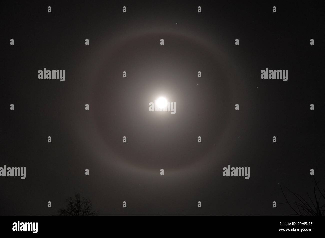 Lunar halo, photographed on a still, frosty winter night. Stock Photo