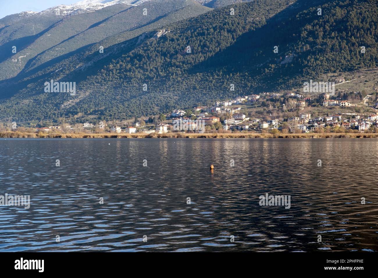 Ioannina city Pamvotis Lake, Epirus Greece. Giannena town built next to water, historical traditional destination, snowy mountain peak background. Stock Photo