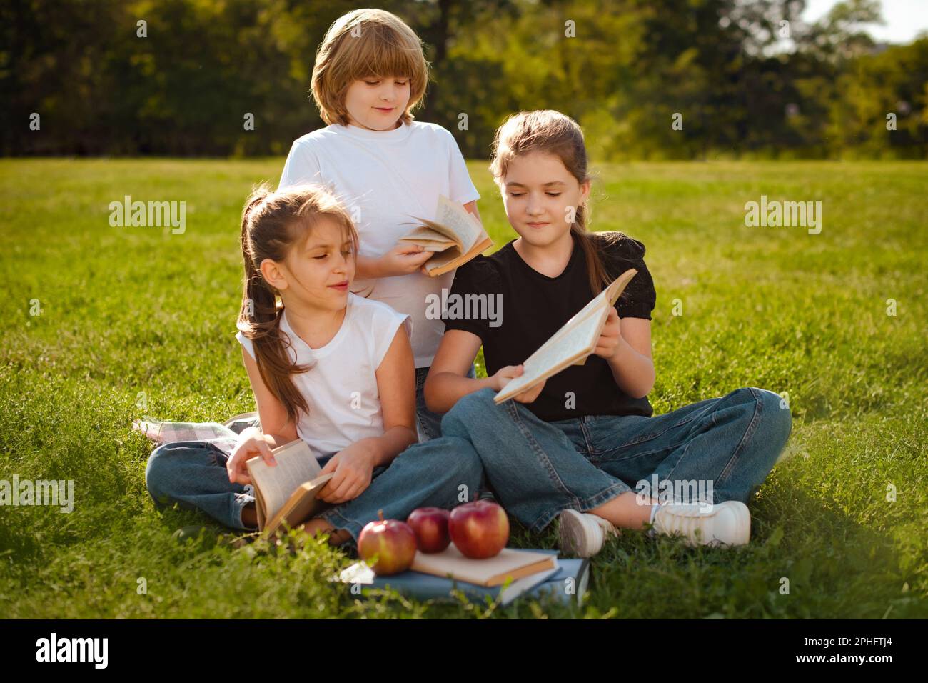 Kids sitting and reading literature. Boy and girls learning or studying