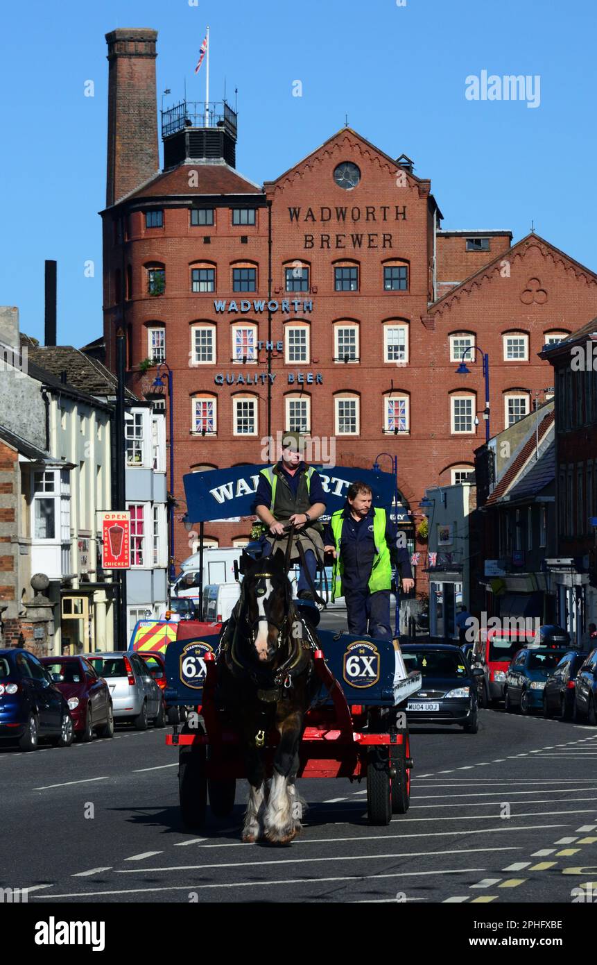 Wadworth shire horse Max delivering beer in Devizes by dray, passing