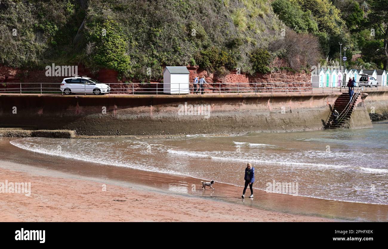 A beach hut and car moving along the narrow promenade at Goodrington ...