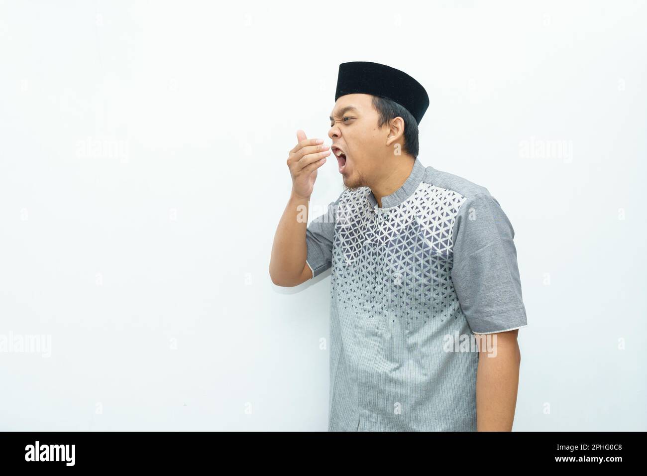 Portrait of Asian Indonesian Muslim man smells the mouth during Ramadan