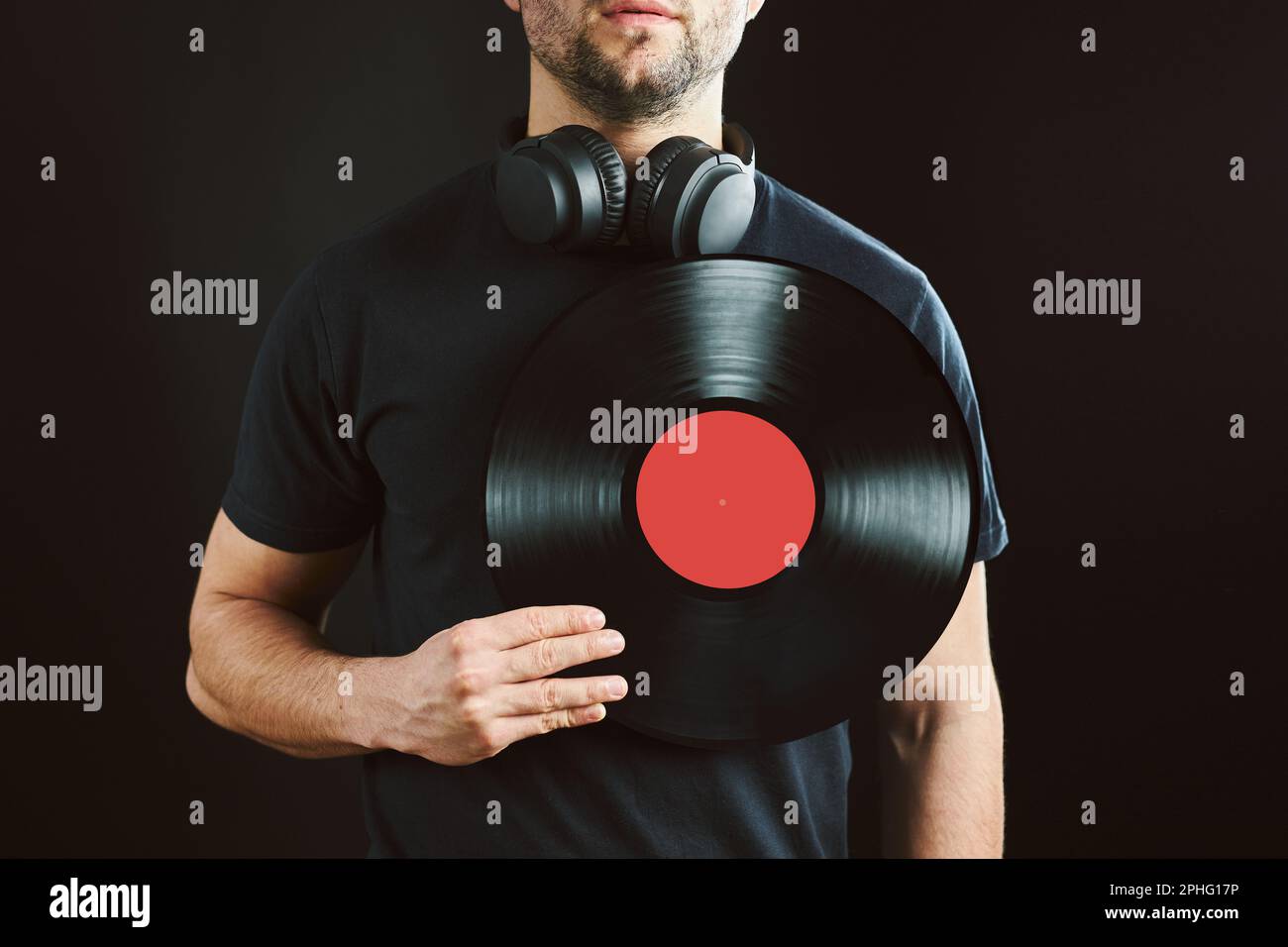 man-holding-vinyl-record-over-heart-music-passion-vintage-music-style