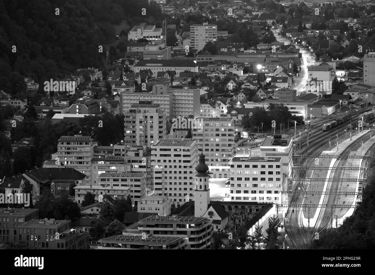 Black and white photo of the small town Feldkrich in Vorarlberg, Austria in the evening Stock Photo