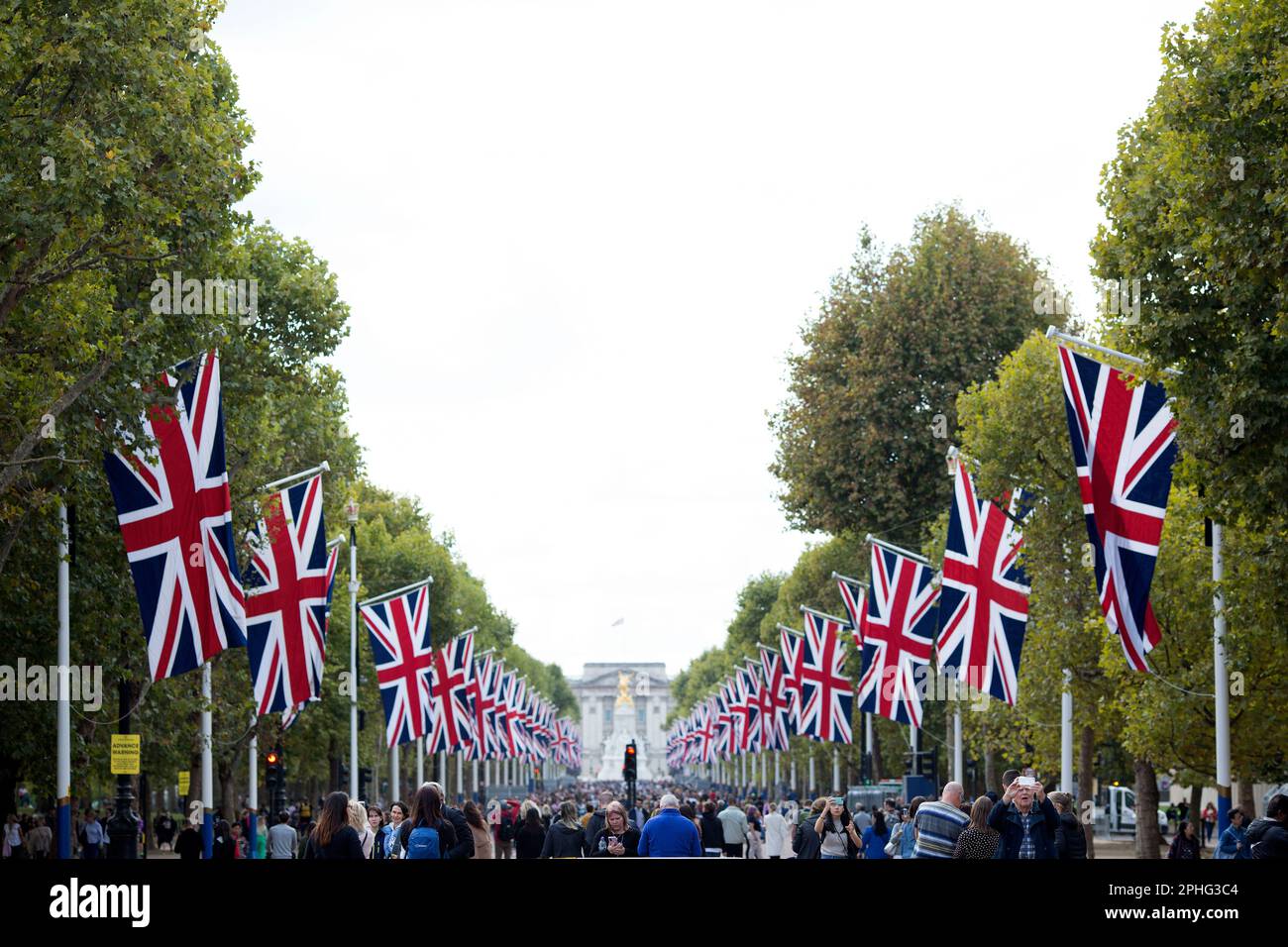 People walk on The Mall in London as people gather around Buckingham Palace on the first Saturday since the state funeral of Queen Elizabeth II. Stock Photo