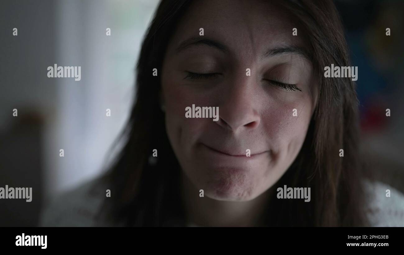 Woman changing emotion pressing lips serious. Portrait face