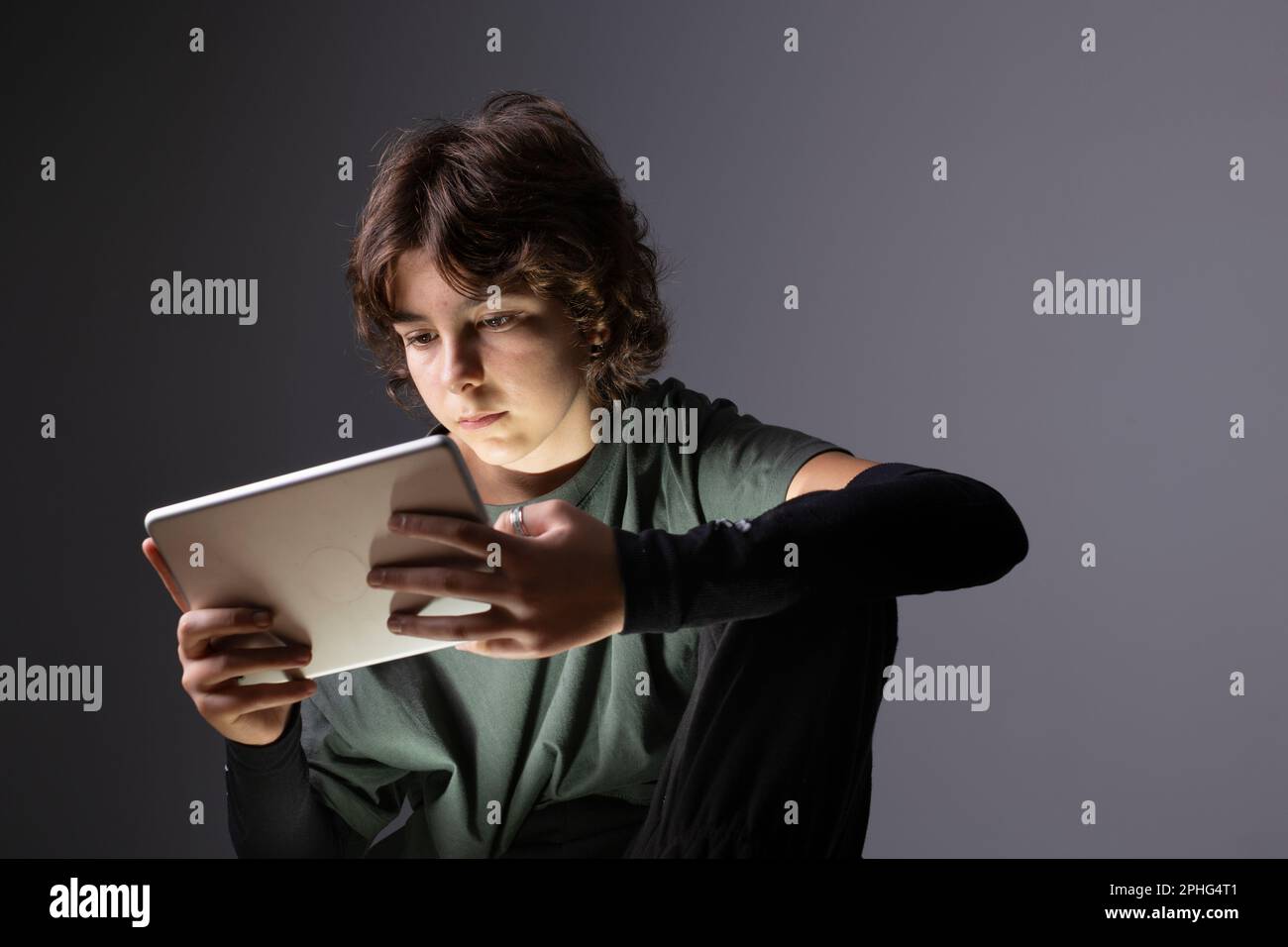 A teenage girl surfs the with a tablet or electronic device in