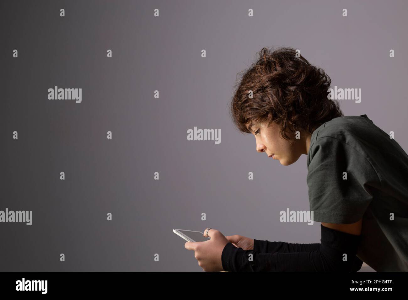 A teenage girl surfs the with a tablet or electronic device in