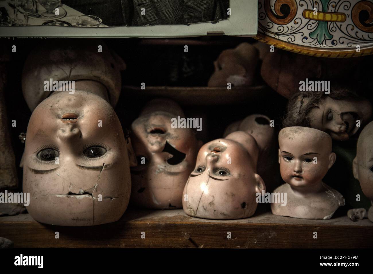 Broken heads of antique dolls line the shelves at the Squatriti family's workshop in Rome, which is also known as the city's 'Doll Hospital'. Stock Photo