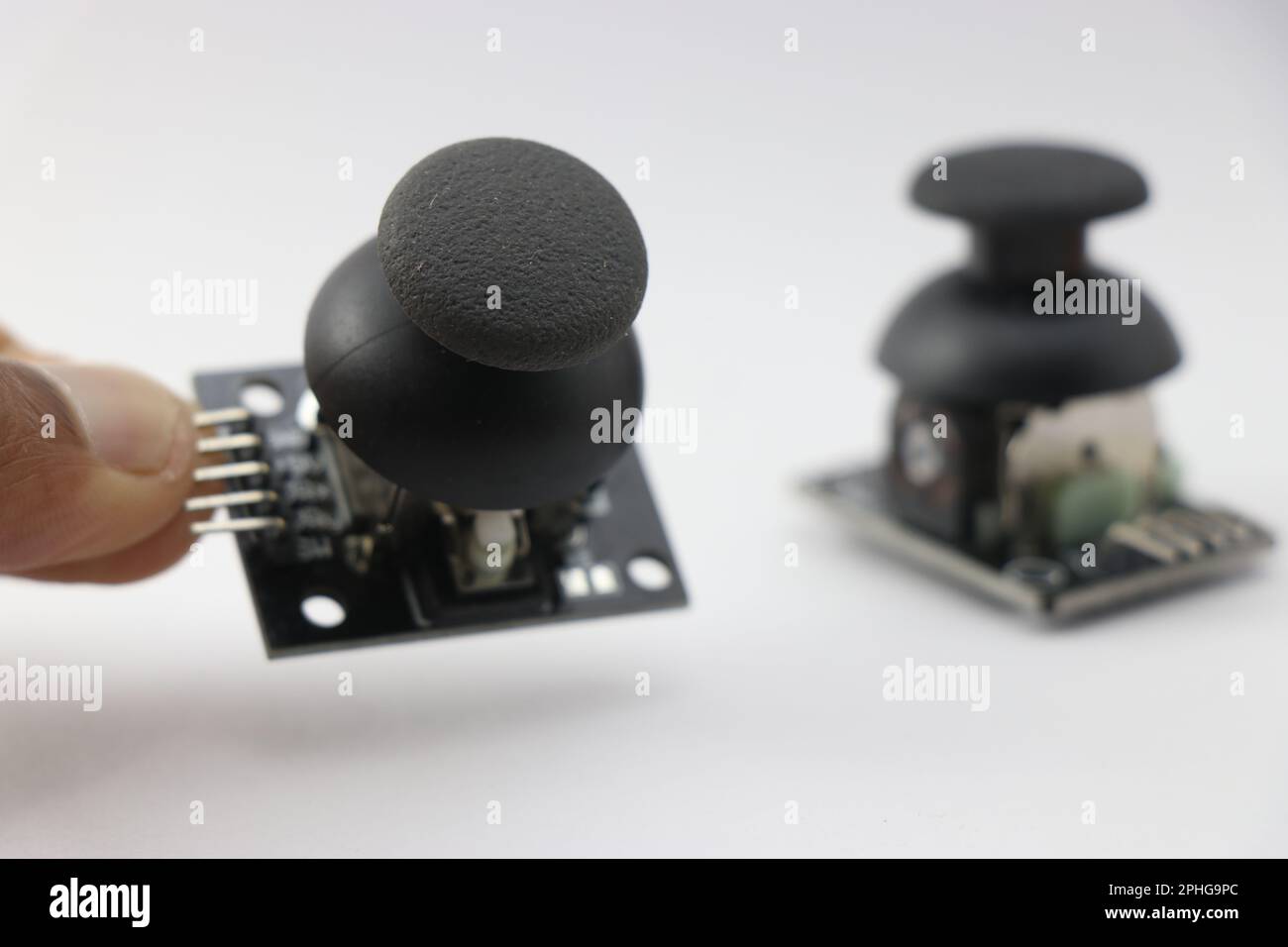 Joystick module with dual axis control used in making electronics projects held in the hand Stock Photo