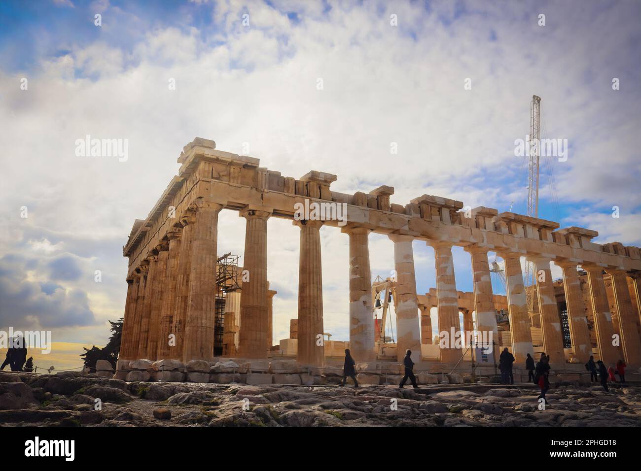 Tourists around the  Parthenon on the Acropolis in Athens Greece - Building undergoing reconstruction with cranes and other machinery Stock Photo