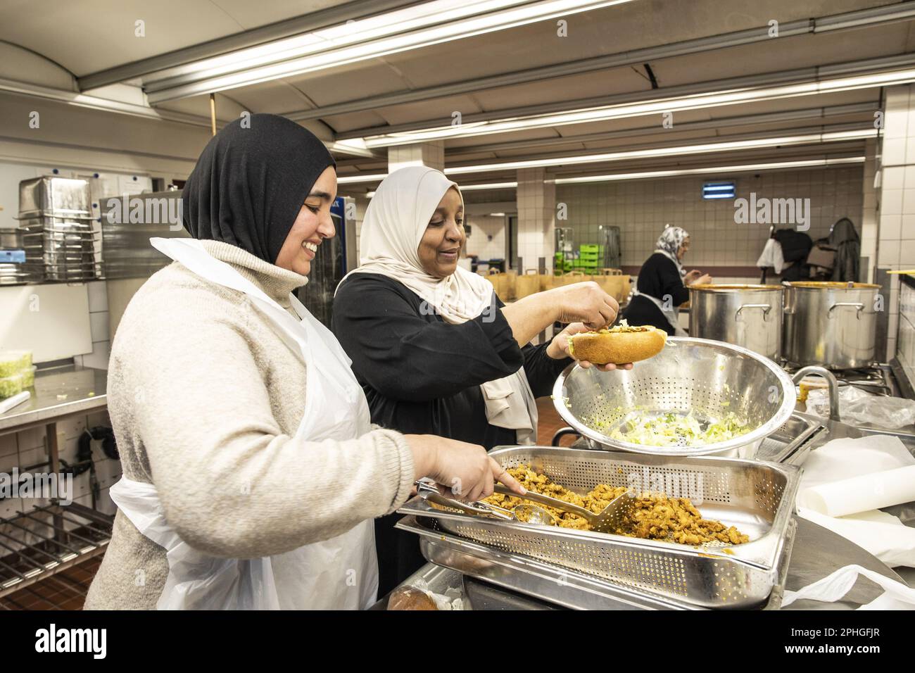 AMSTERDAM Volunteers hand out healthy packages for the iftar in a