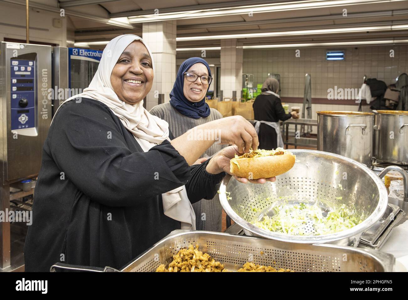 AMSTERDAM Volunteers hand out healthy packages for the iftar in a