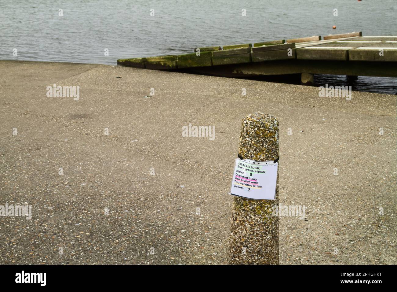 Humorous, Comical Sign With A Score For Injuries Occuring On A Seaweed Covered Slipway Warning Of The Potential Danger Of Slipping, Mudeford Quay, Chr Stock Photo