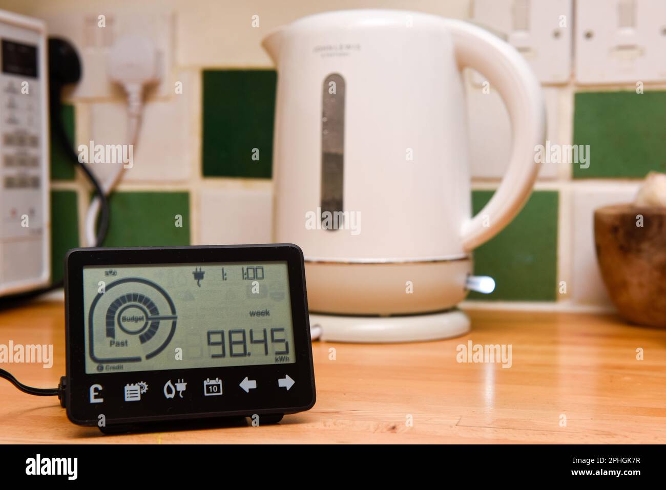 Smart energy meter in a home interior to monitor electricity usage in the house and reduce cost of living price Stock Photo