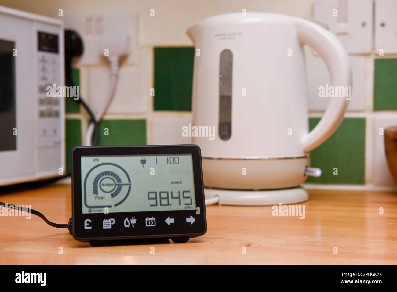 Smart energy meter in a home interior to monitor electricity usage in the house and reduce cost of living price Stock Photo