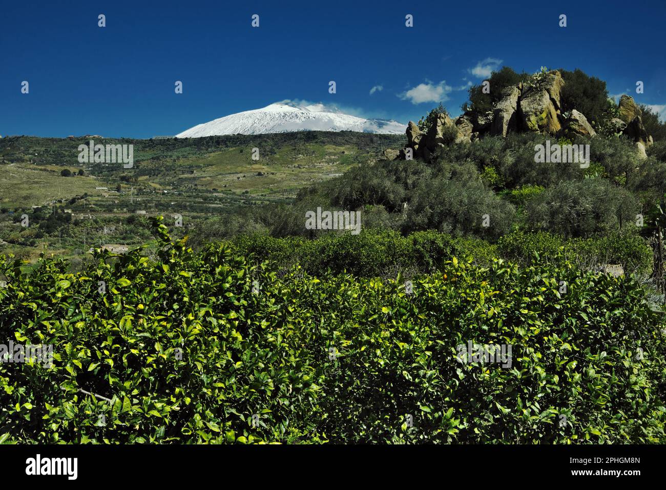 spring in Sicily landscape with Mount Etna covered in white snow ...