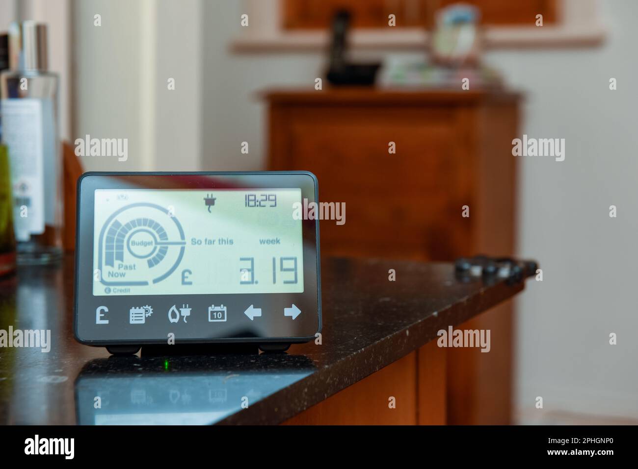 Smart energy meter in a home interior to monitor electricity usage in the house and reduce cost of living price Stock Photo