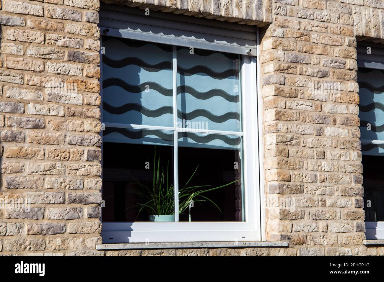 New plastic muntin windows on a residential building with clinker brick