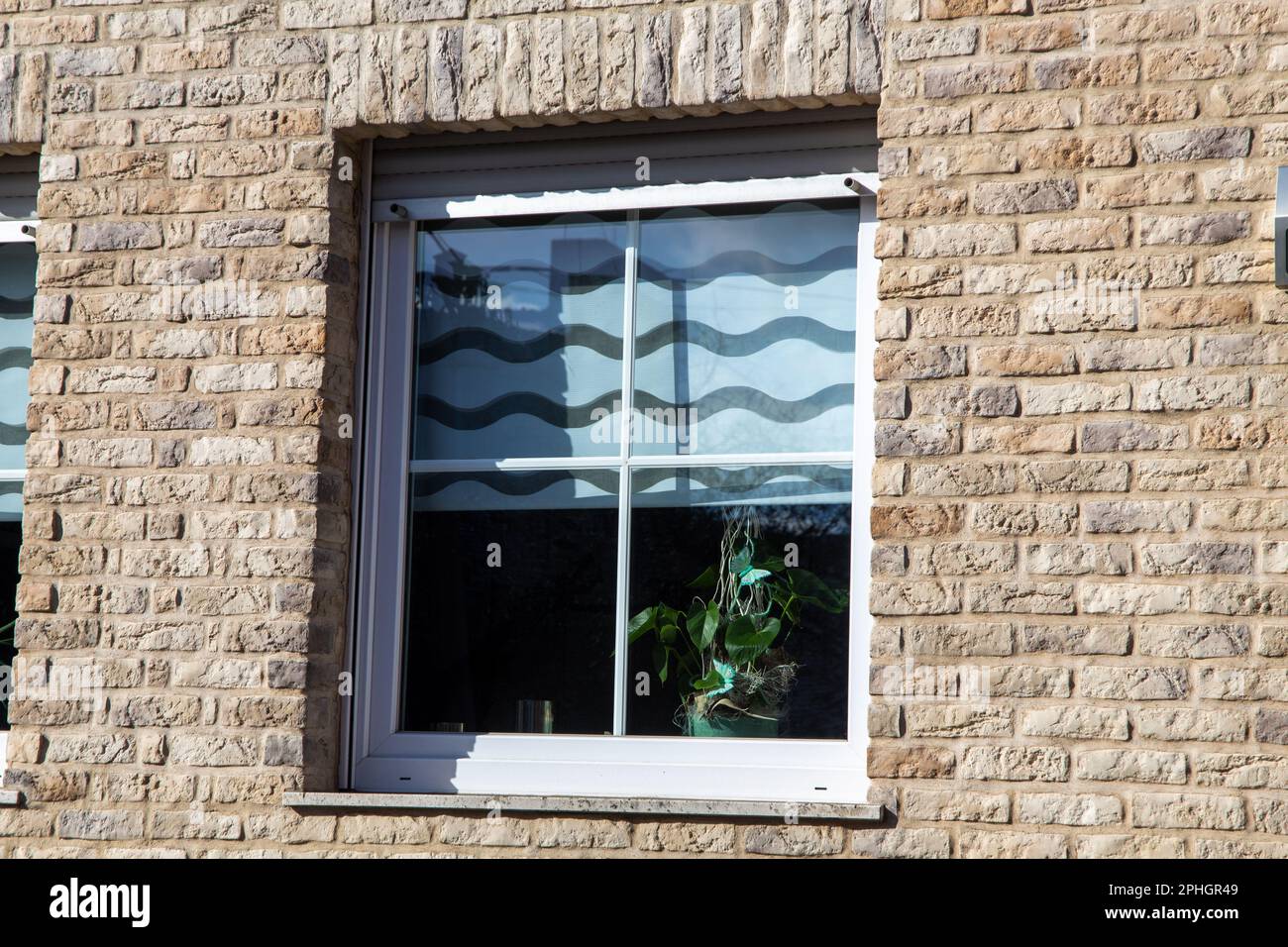 New plastic muntin windows on a residential building with clinker brick