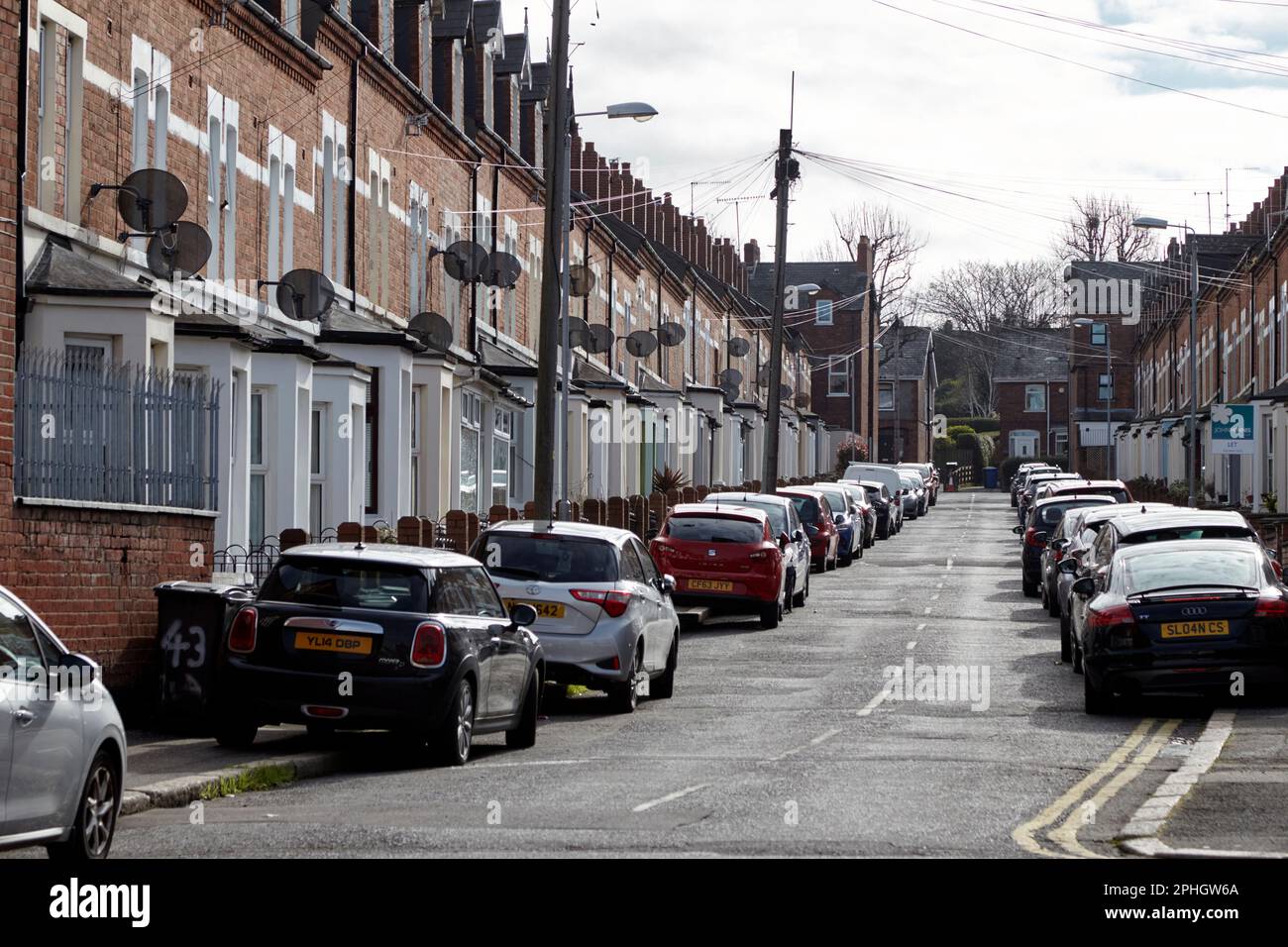 victorian terraced houses in cheviot avenue packed with cars parking on